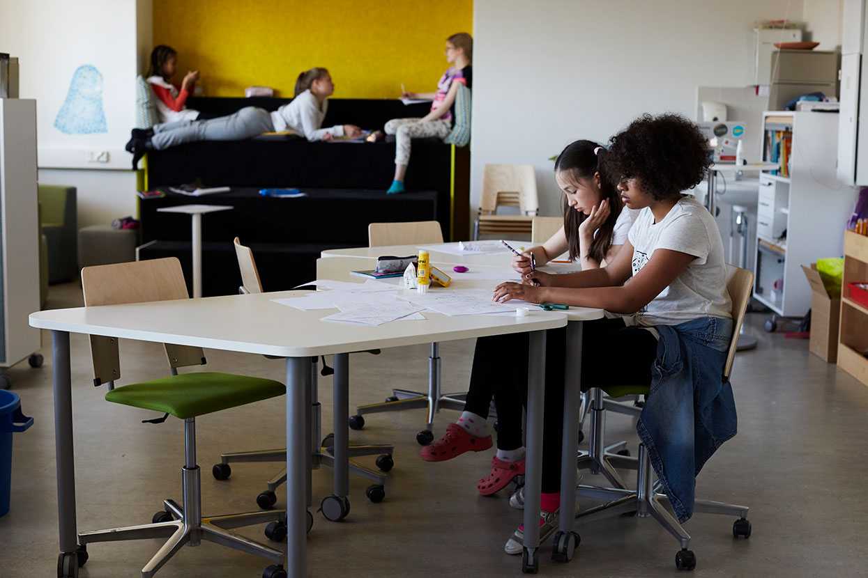 Pupils at English School in Helsinki studying on Martela's Grip chairs and Salmiakki tables