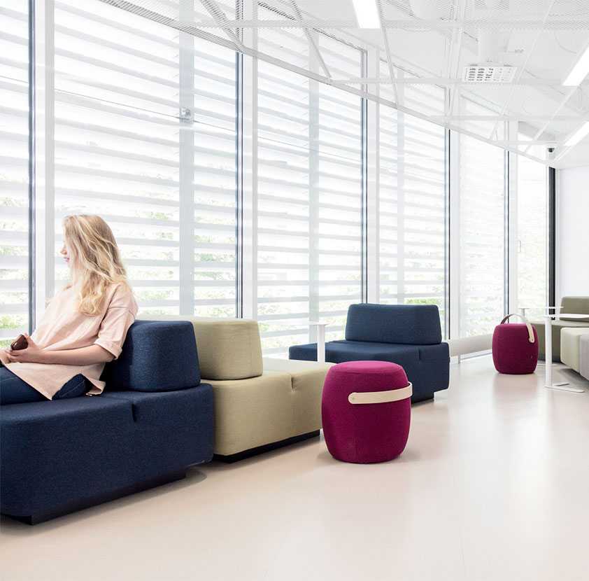 Girl sitting on Martela's Movie sofa at Perho Culinary School in Helsinki