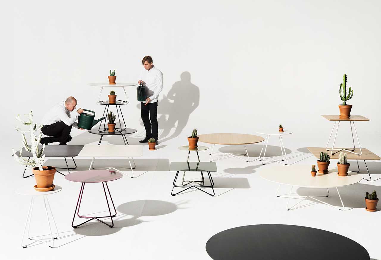 Two people watering plants on Scoop tables