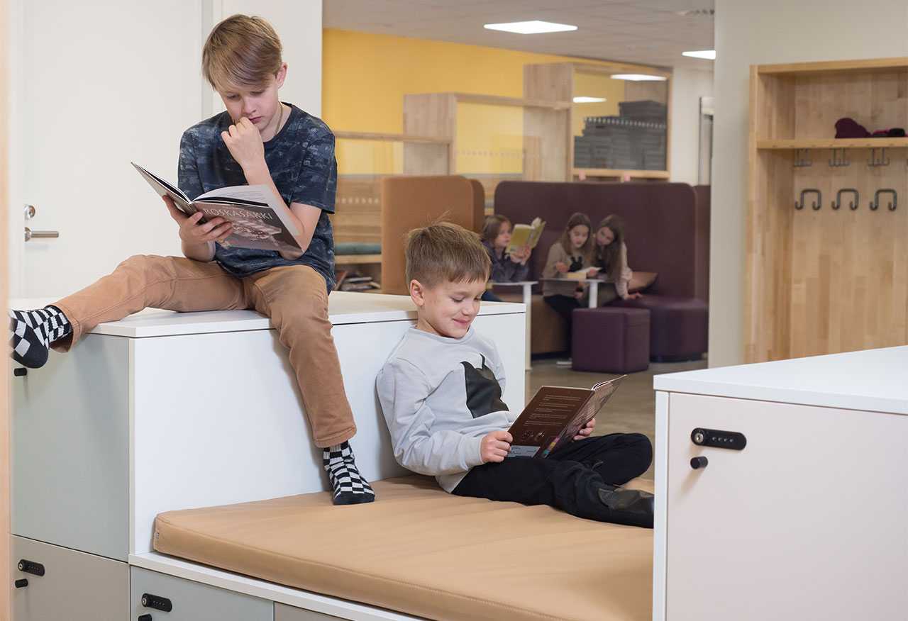 Two boys reading books