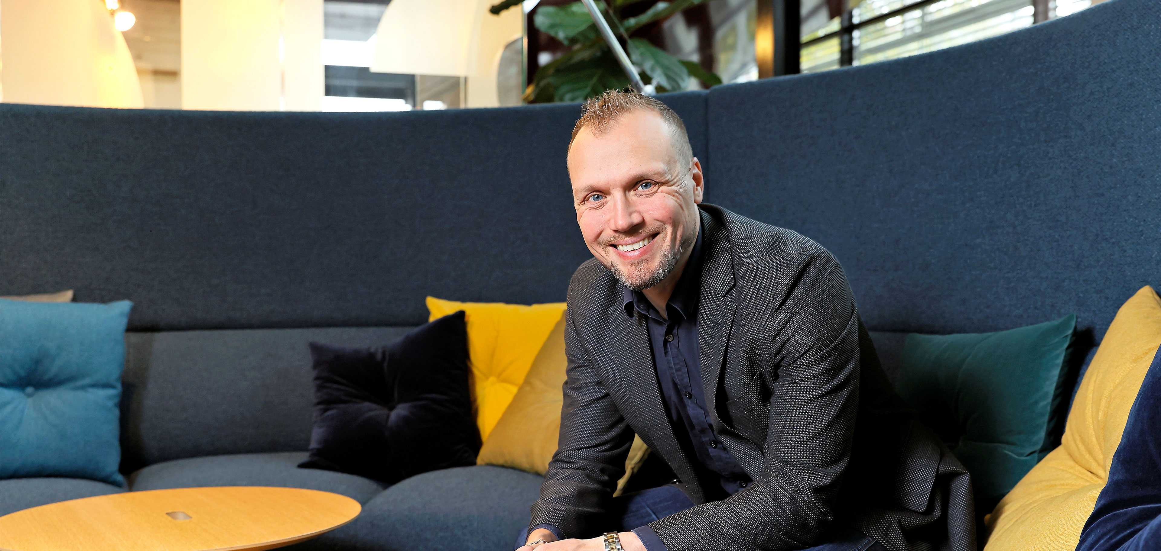 Martela's CEO Artti Aurasmaa sitting on a sofa