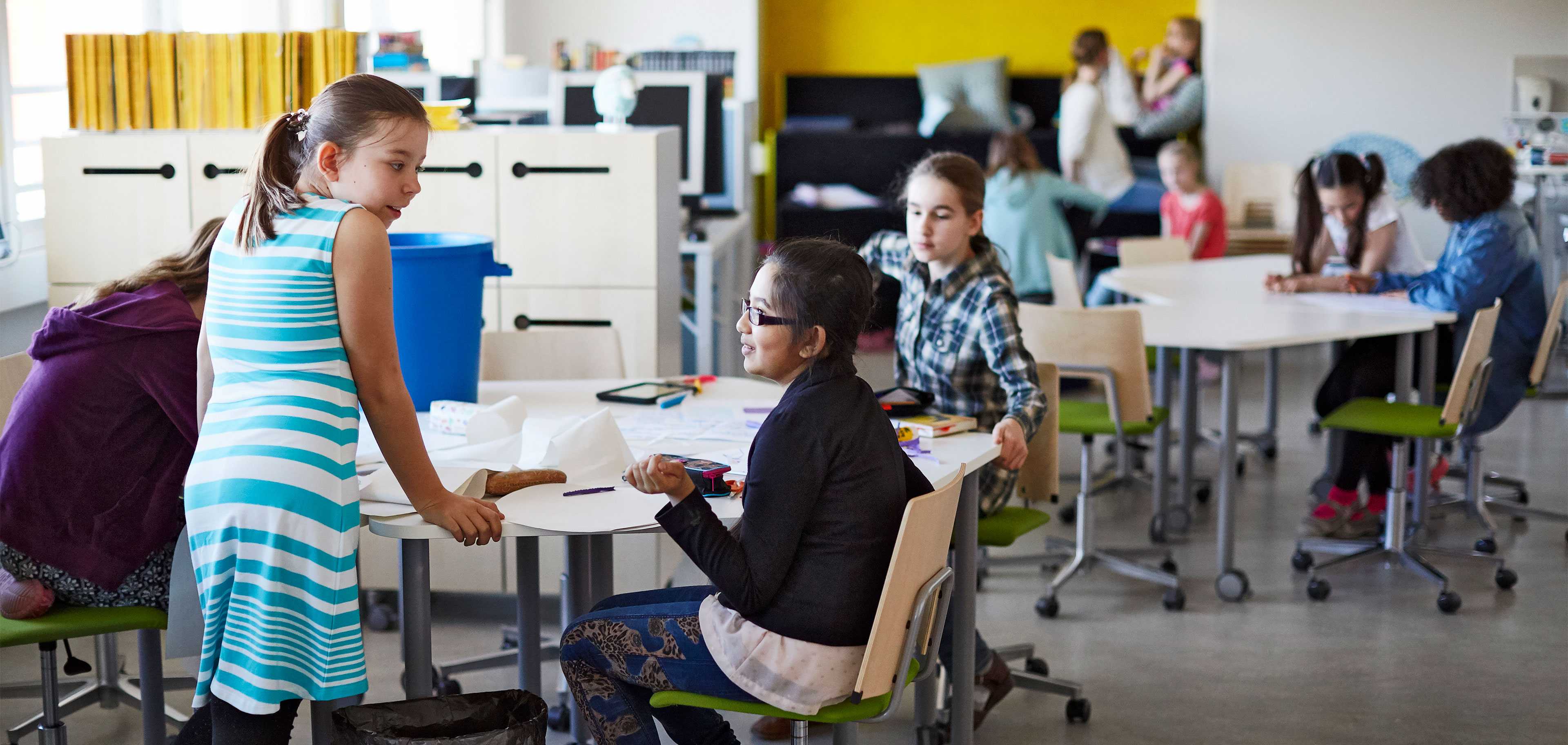 Pupils studying at Martela's Salmiakki tables and Grip chairs in English School in Helsinki