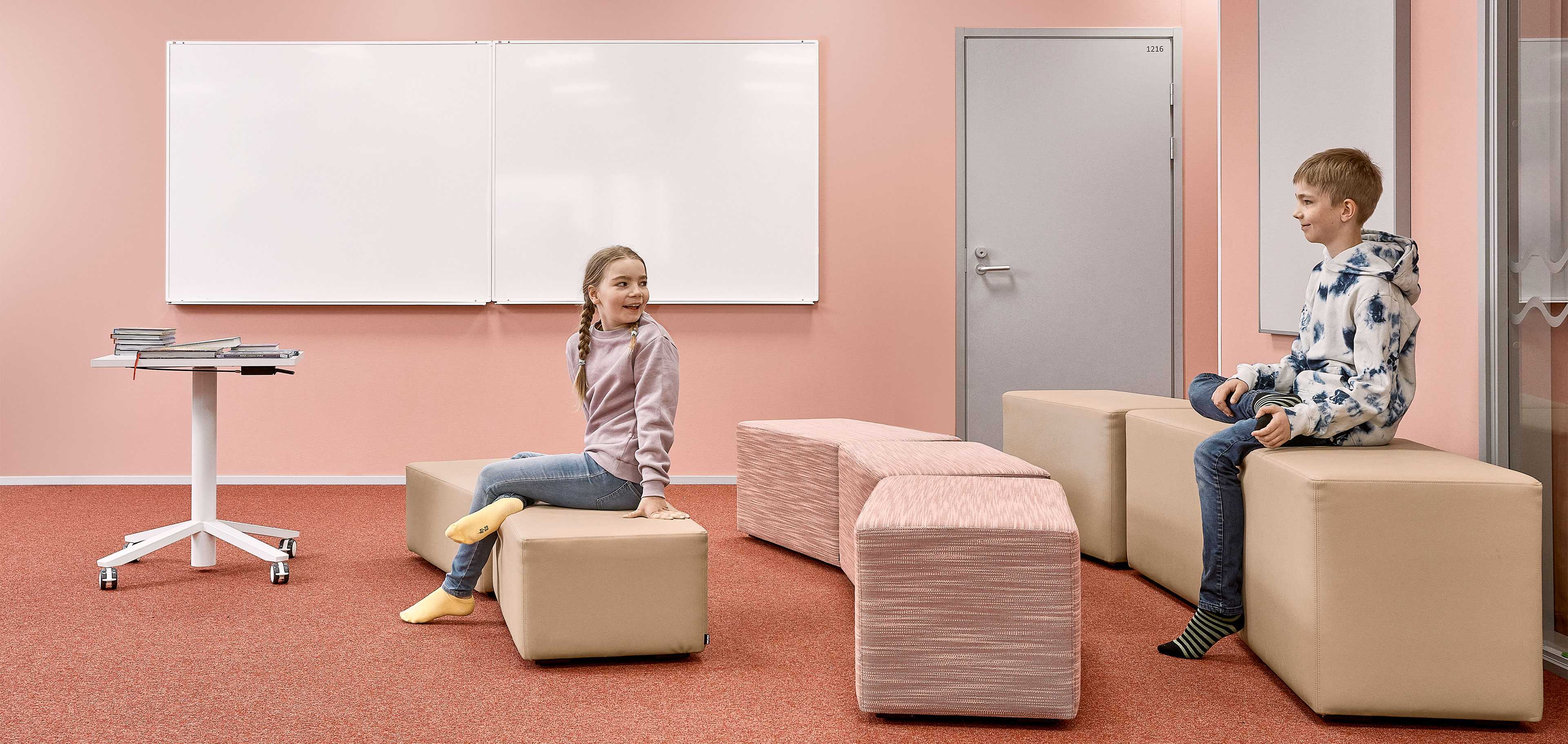 Two pupils sitting on Bit stools